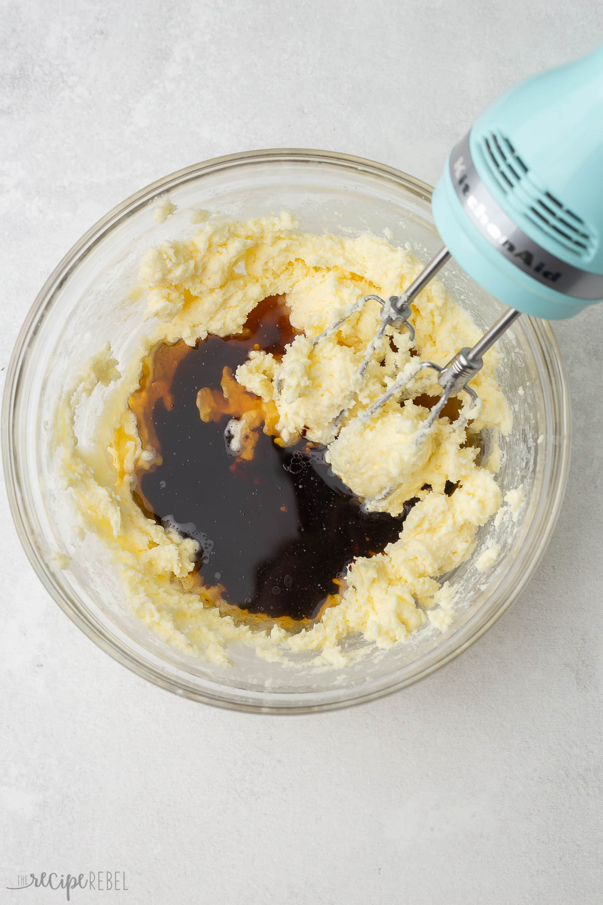 ingredients in a glass mixing bowl with electric mixer.