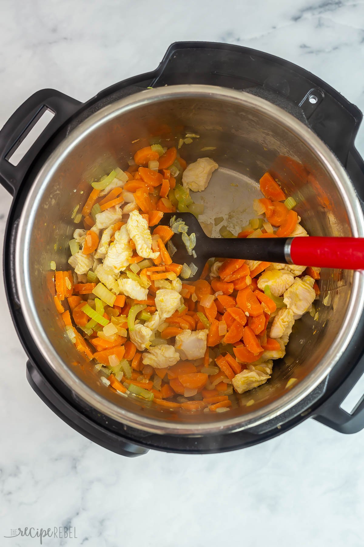 chicken pieces added to vegetables sauteeing in instant pot.