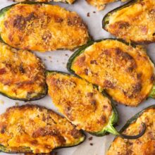 close up of jalapeno poppers on parchment paper.