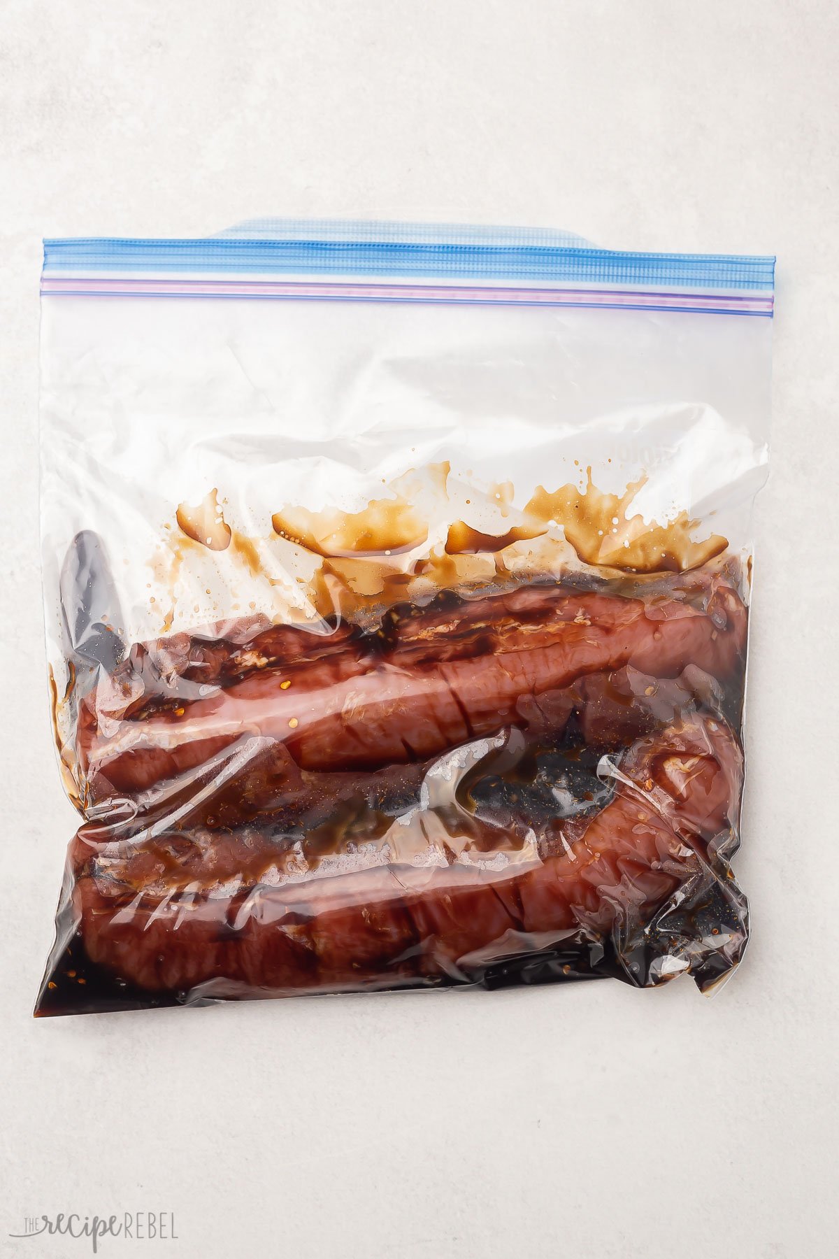 pork tenderloin and marinade in closed zipper seal bag.