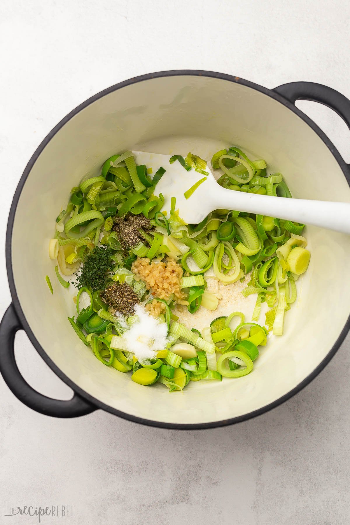 overhead shot of a pot full of chopped leeks and spices