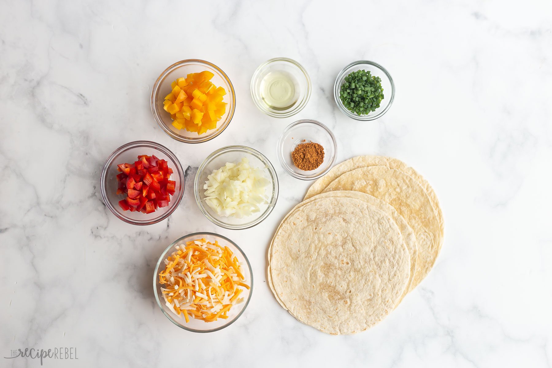 Overhead view of ingredients in glass bowls for air fryer quesadillas.
