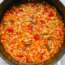 square image of alphabet soup in pot.