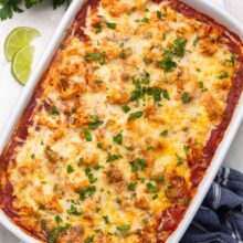 Top view of chicken enchilada casserole in a large white dish.