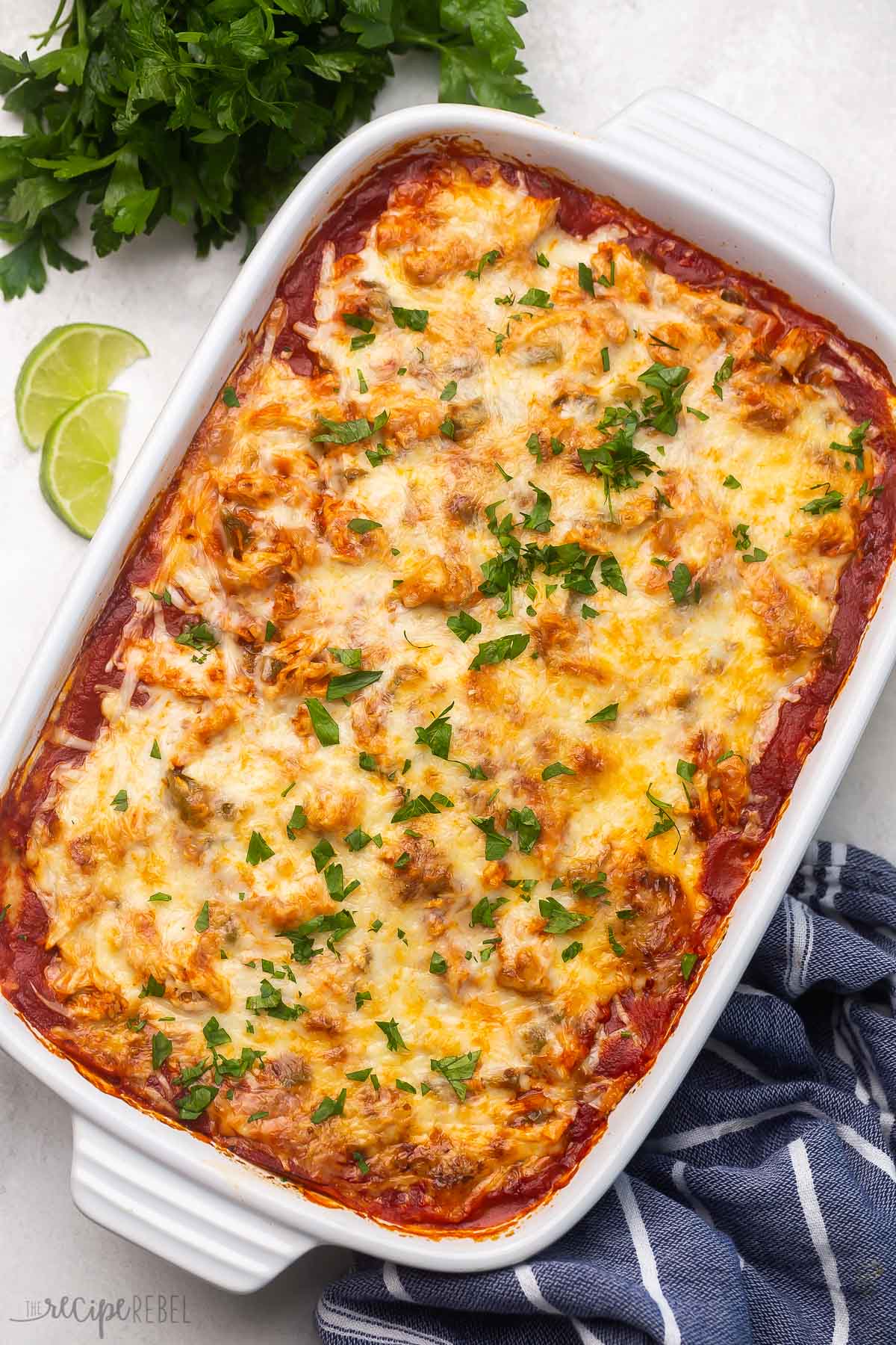 Top view of chicken enchilada casserole in a large white dish. 