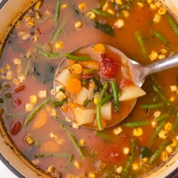 Top view close up of vegetable soup in a dutch oven.