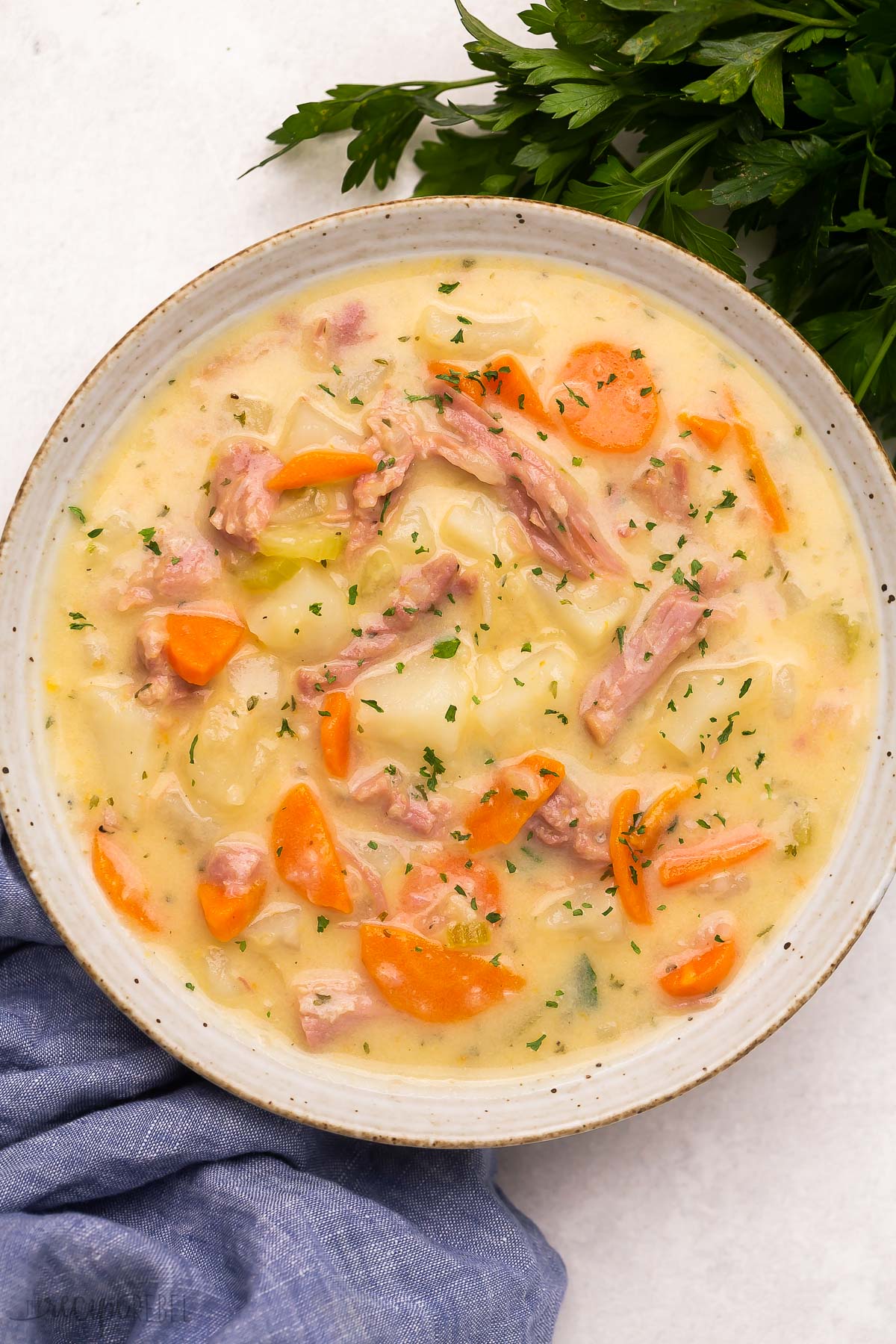 Top view of a bowl filled with creamy potato and ham soup. 