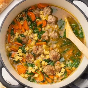 close up square image of cooked Italian wedding soup in pot.