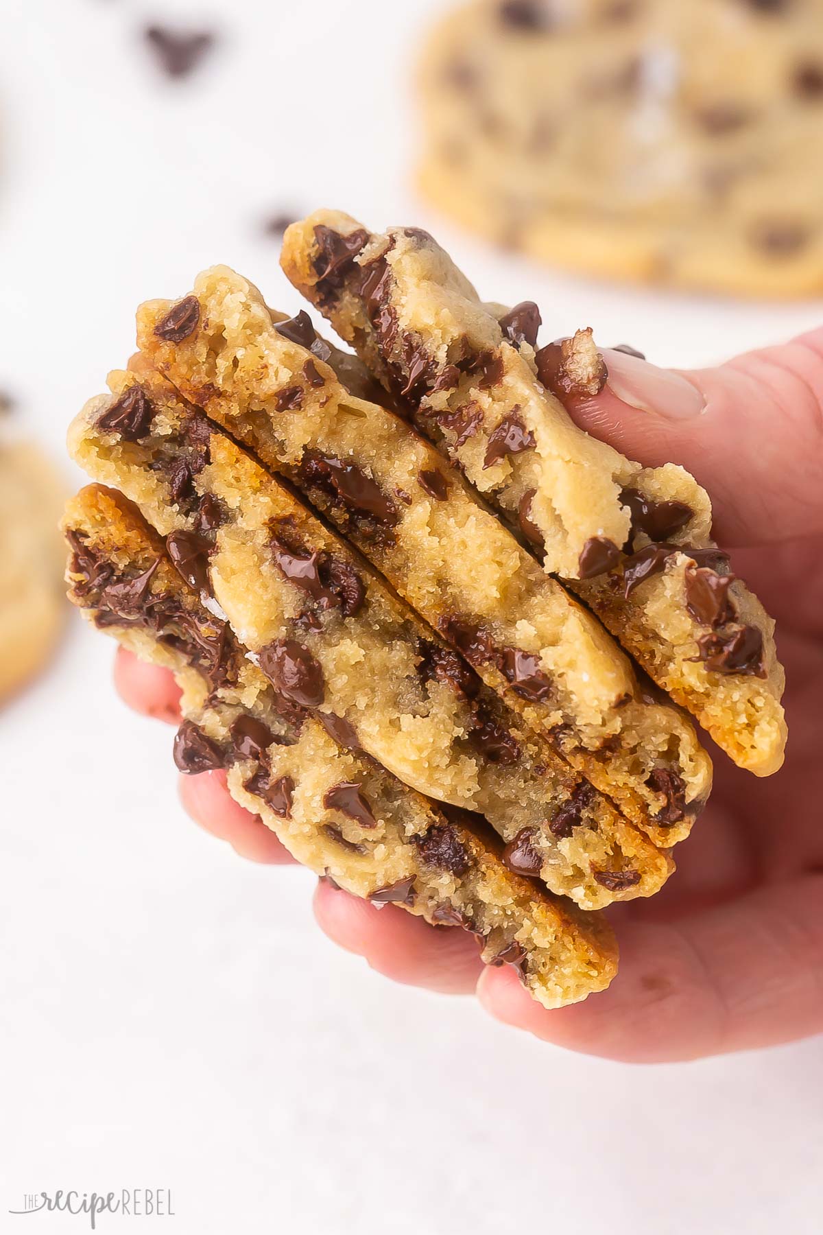 stack of mom's chocolate chip cookies being held in hand.
