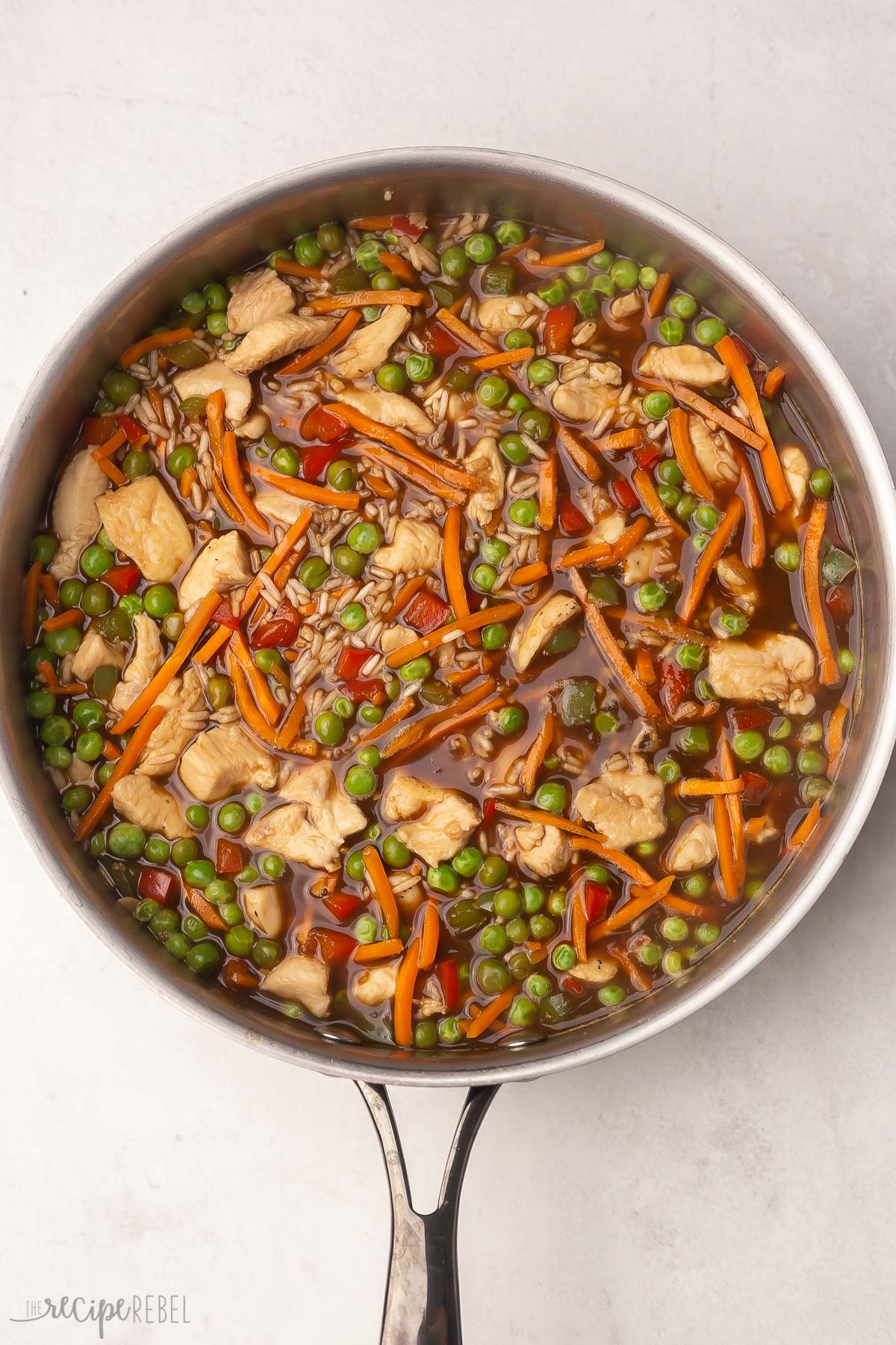 steel pan filled with all teriyaki chicken and rice ingredients.