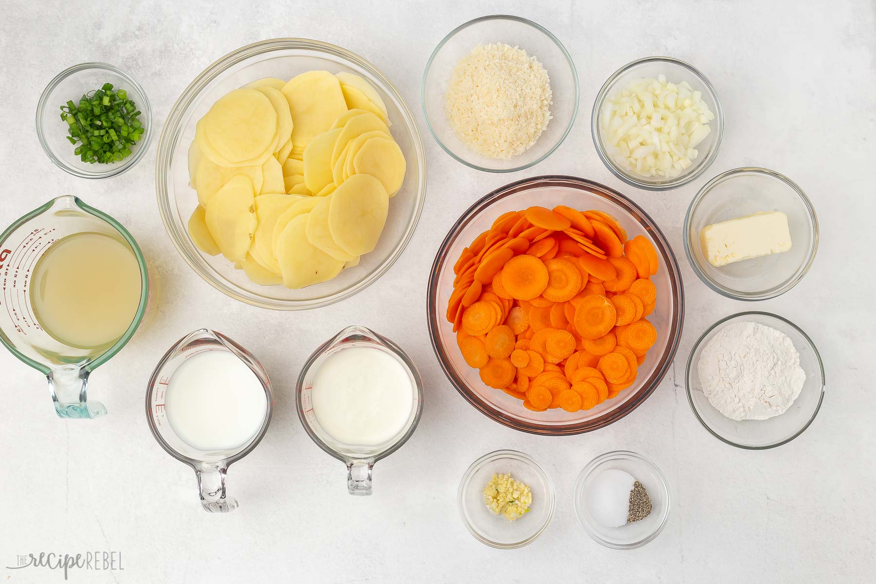 Top view of ingredients needed to make scalloped potatoes and carrots. 