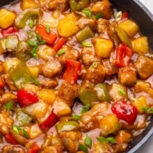 Close up of sweet and sour pork in a frying pan.