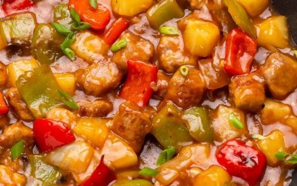 Close up of sweet and sour pork in a frying pan.