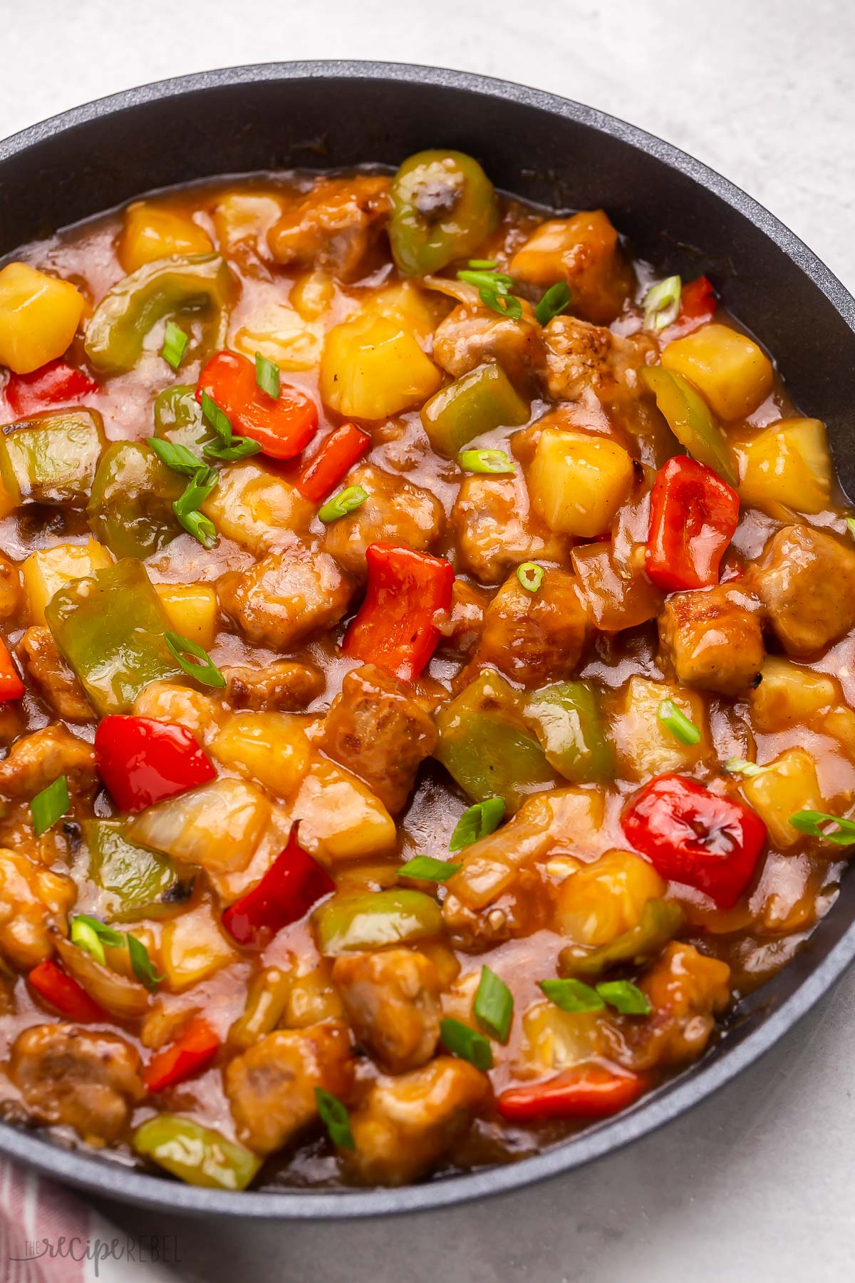 Close up of sweet and sour pork in a frying pan. 