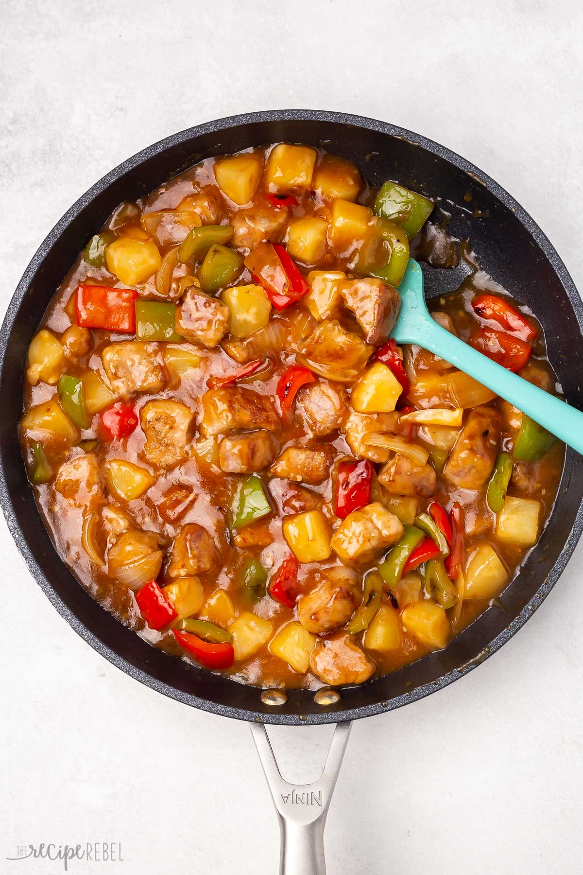 Top view of a skillet with sweet and sour pork being simmered.