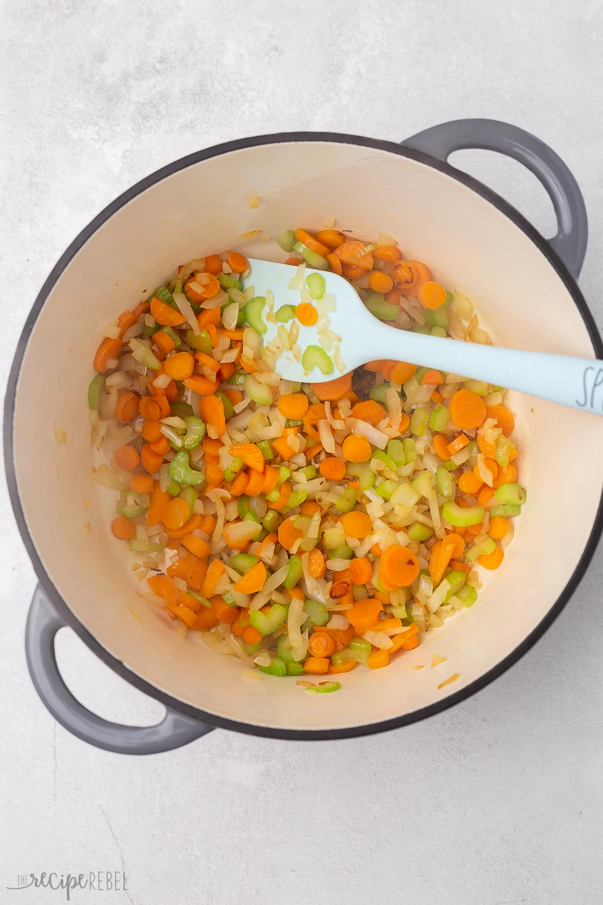 Top view of dutch oven with vegetables in it for making vegetable soup.