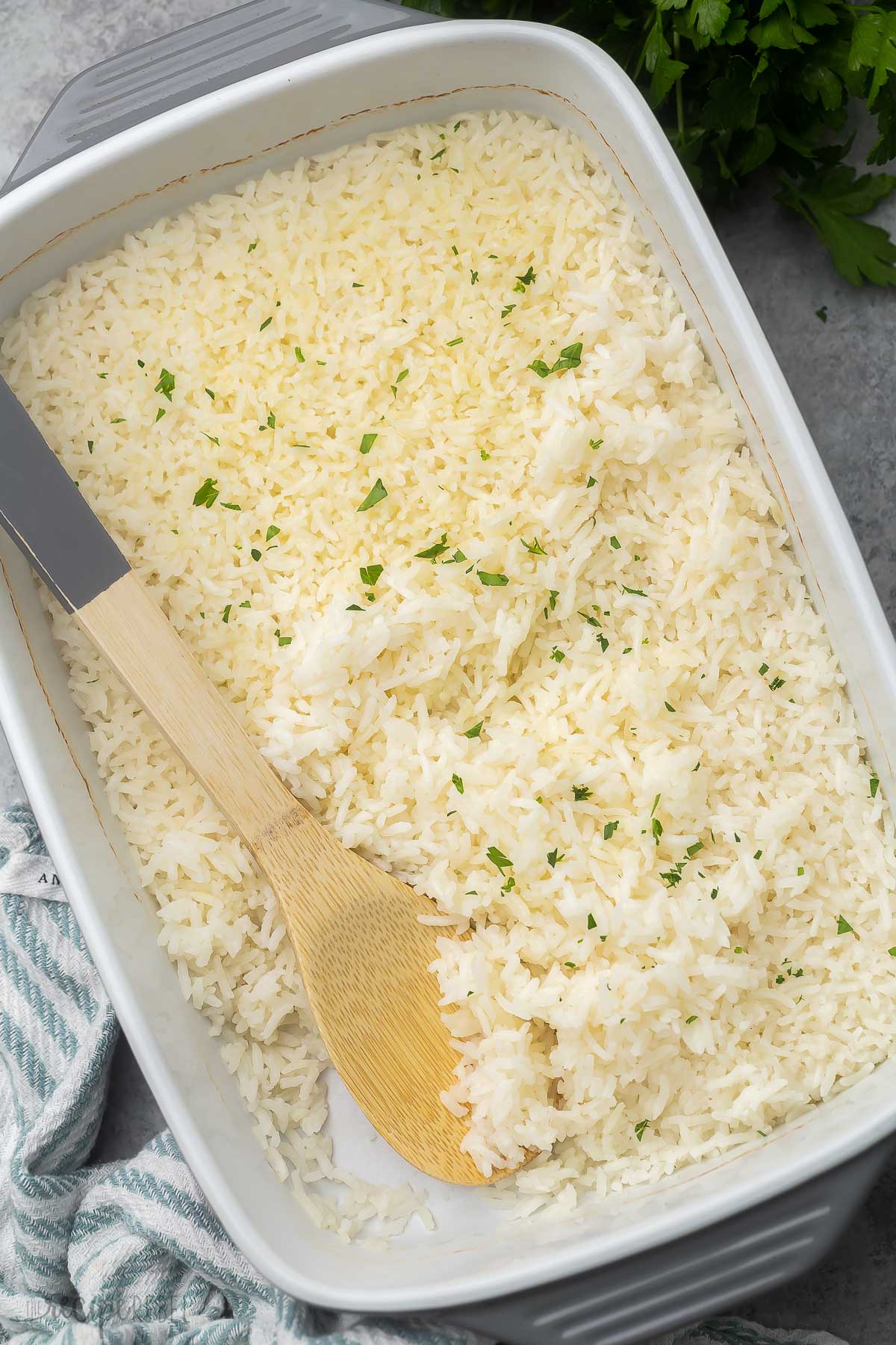 large dish of baked rice garnished with chopped parsley.