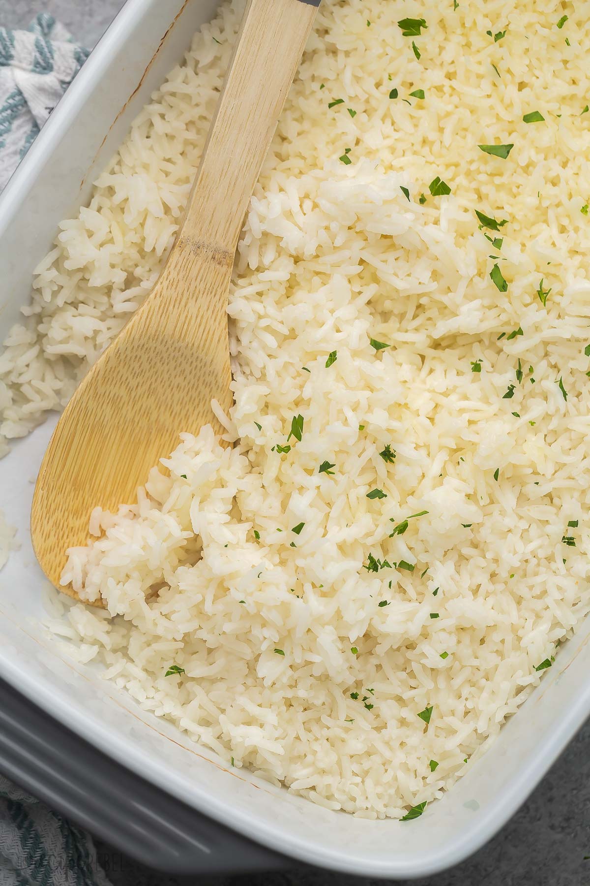 Top view close up of baked rice in and wooden ladle in the pan.