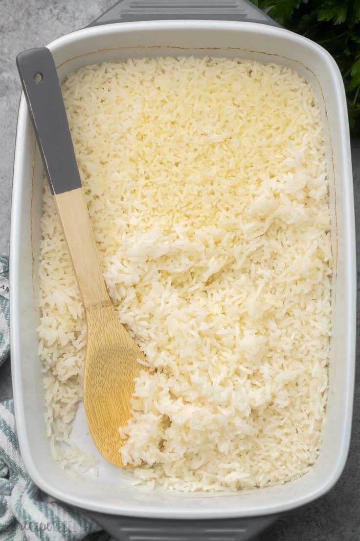 overhead shot of baked rice in baking dish with a wooden ladle.