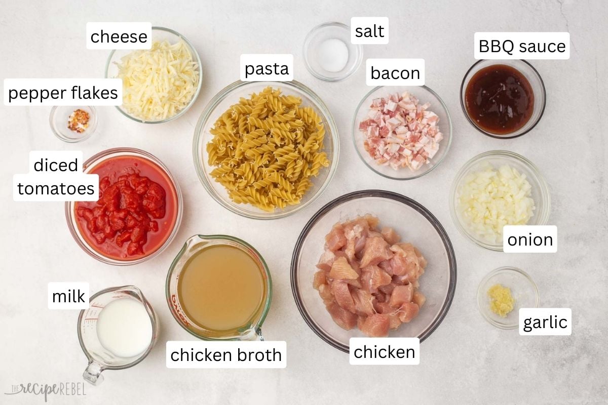 overhead view of bbq chicken pasta ingredients in glass bowls.
