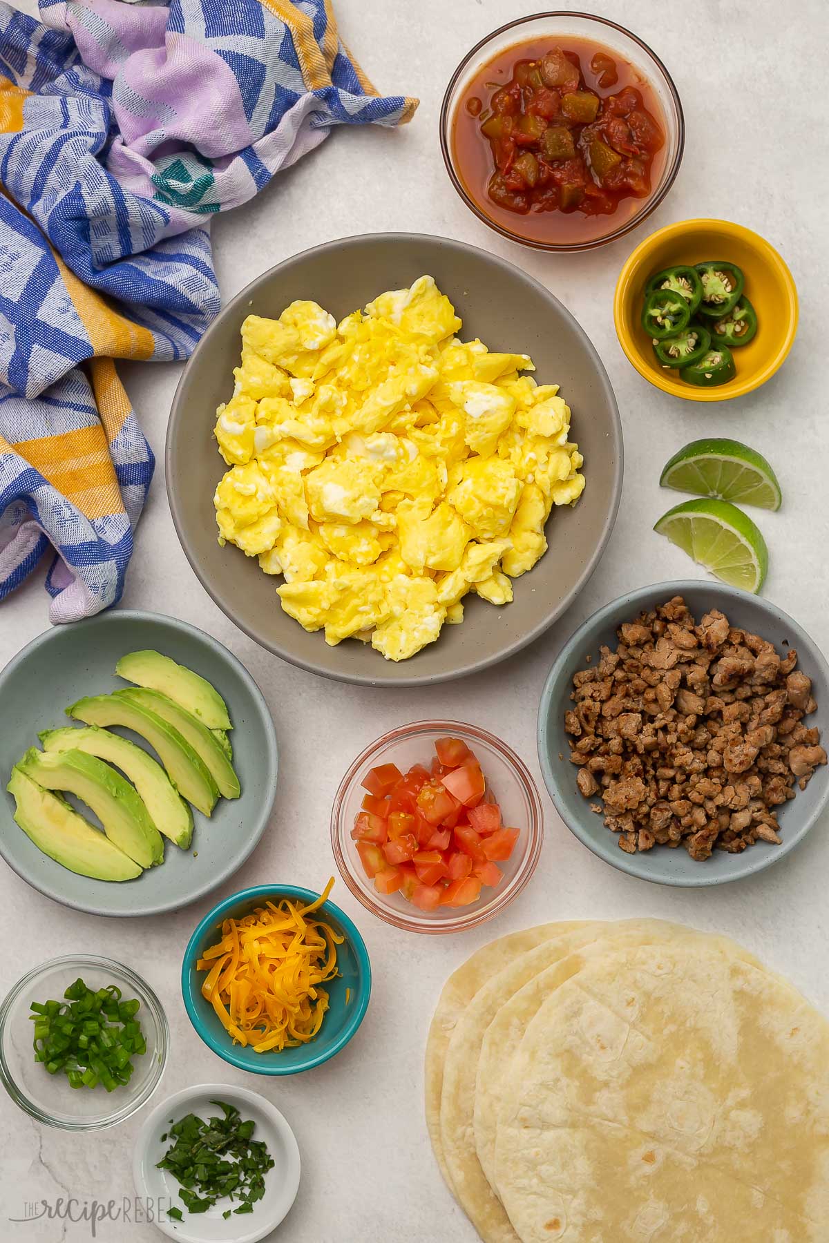 Top view of breakfast taco ingredients and toppings.