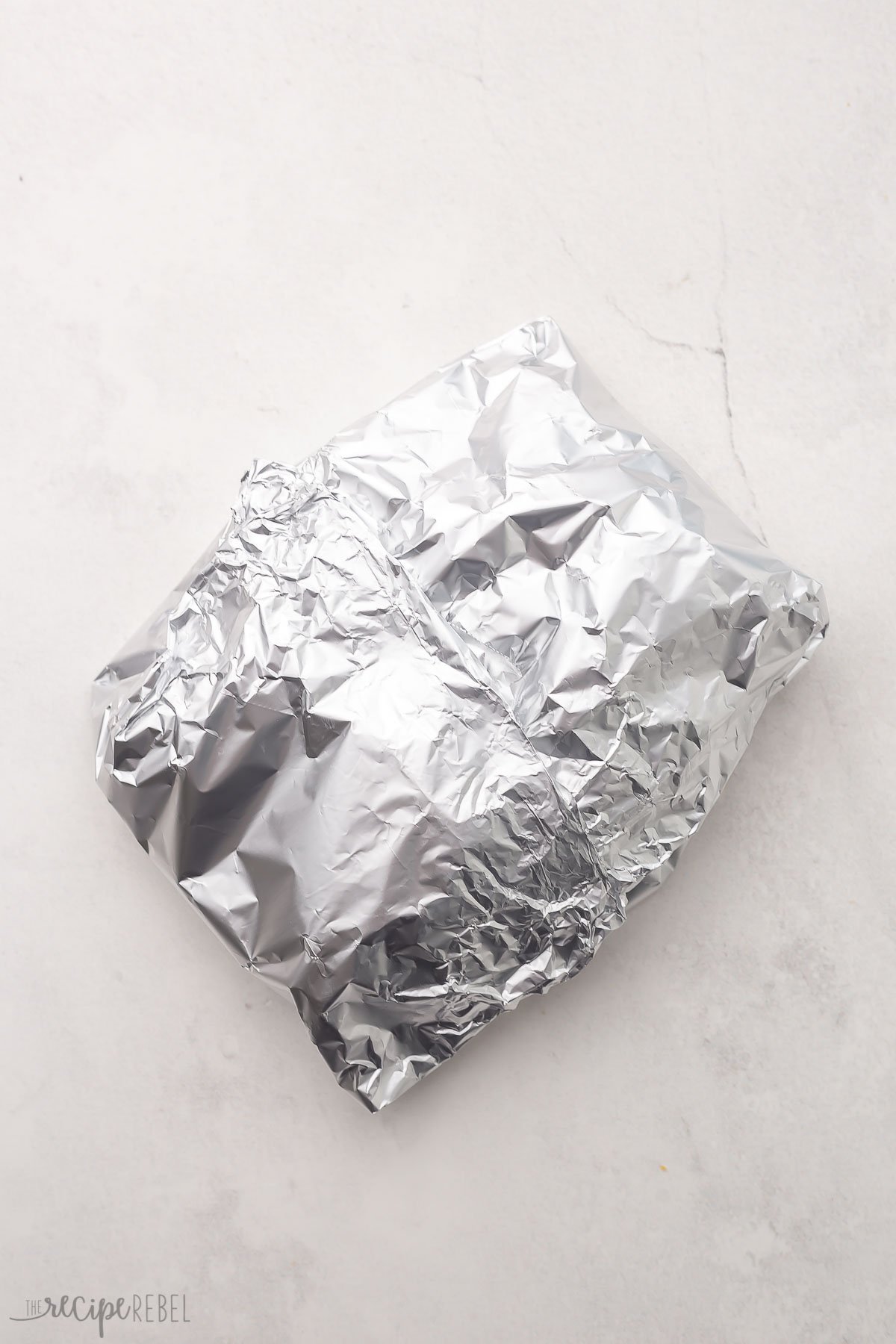 a closed foil pack on a grey surface.