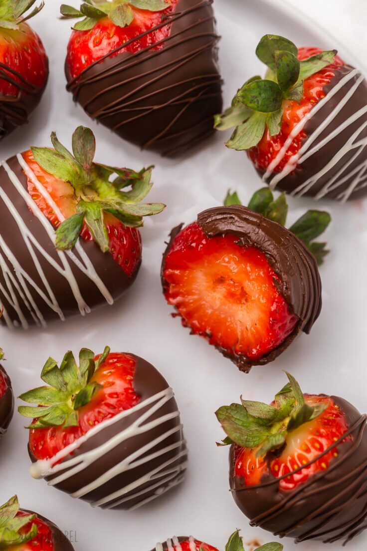 Close up of chocolate covered strawberries on a white plate.