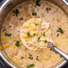 overhead view of instant pot chicken chilli being scooped out of instant pot.