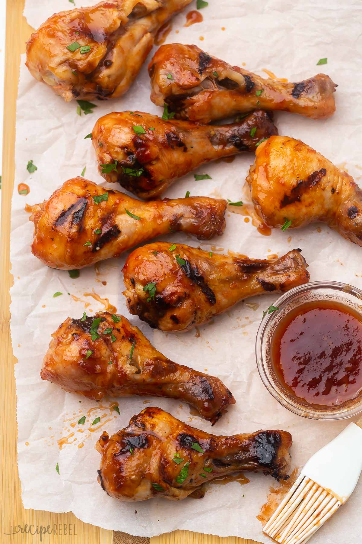 overhead shot of grilled chicken and maple glaze on a cutting board.