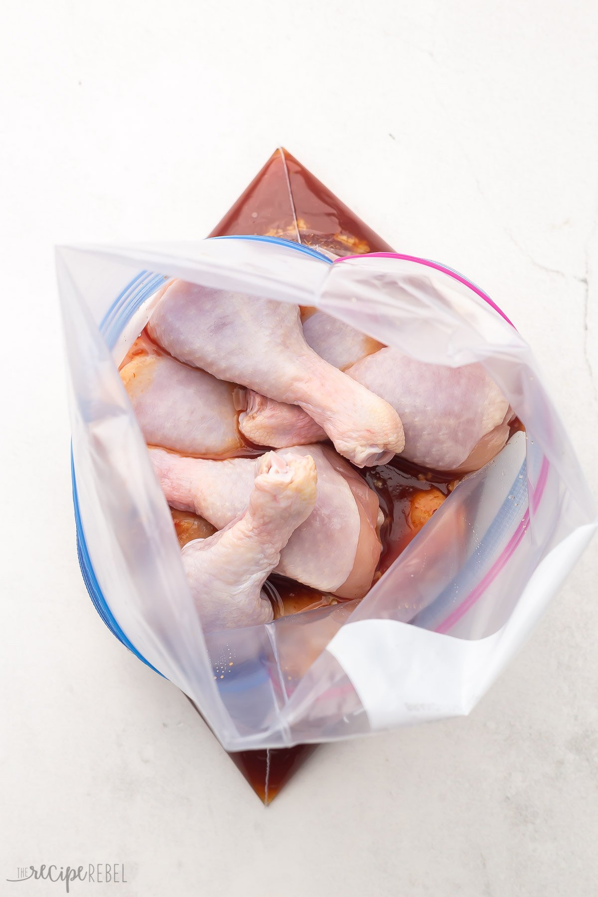 chicken drumsticks and maple glaze in zipper seal bag.