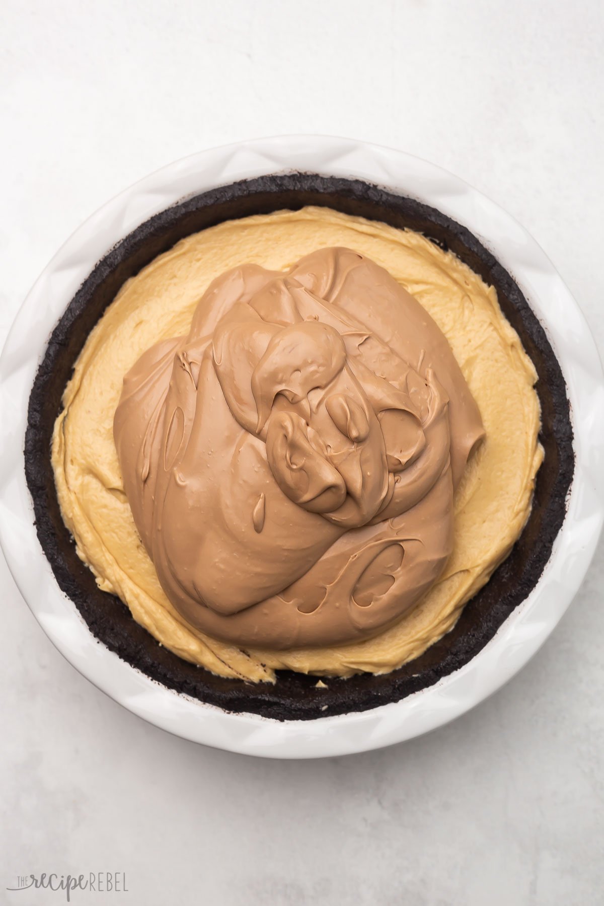 overhead view of pie with chocolate filling added but not yet smoothed.