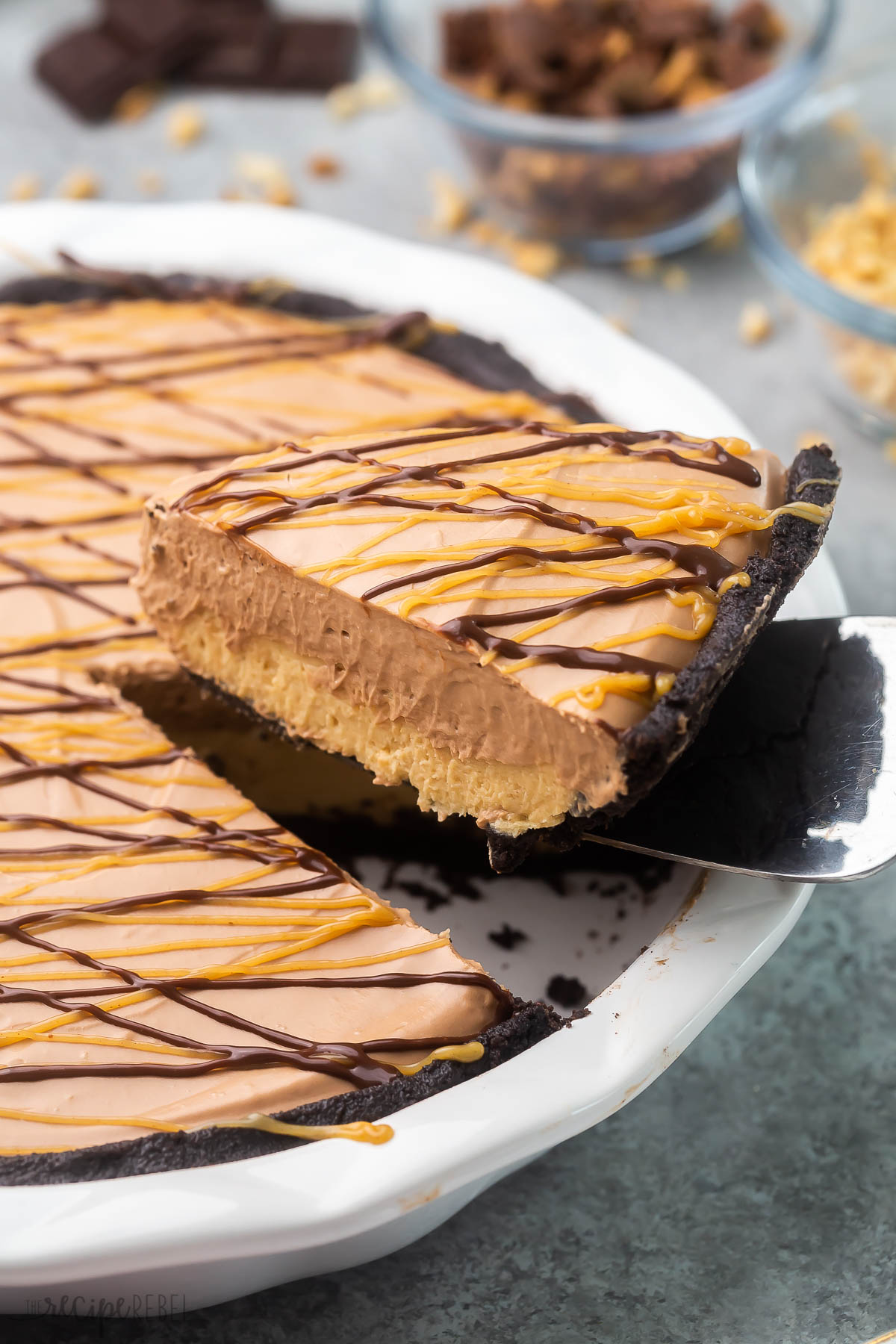 a slice of pie being lifted out of pie dish with topping in the background.