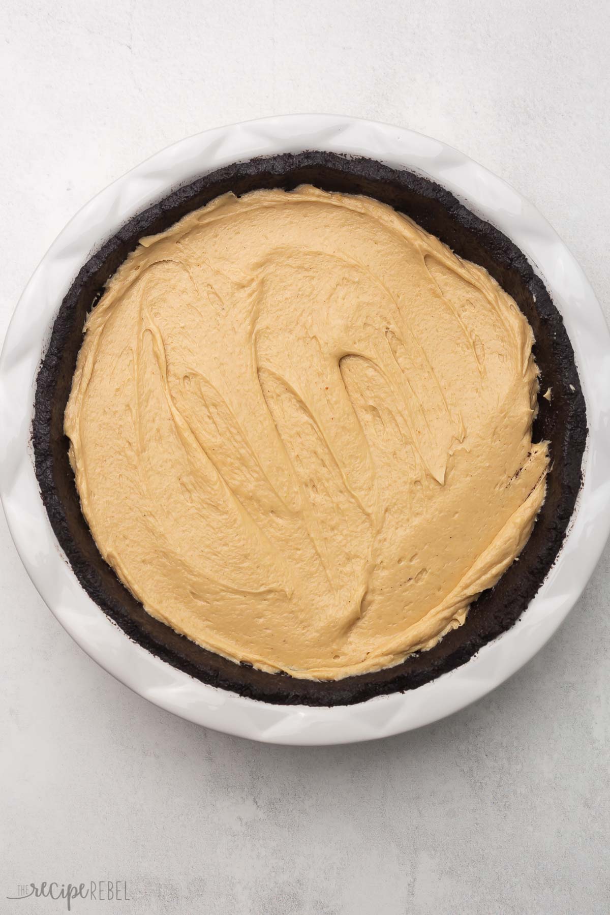 overhead shot of pie crust with peanut butter filling added and smoothed.