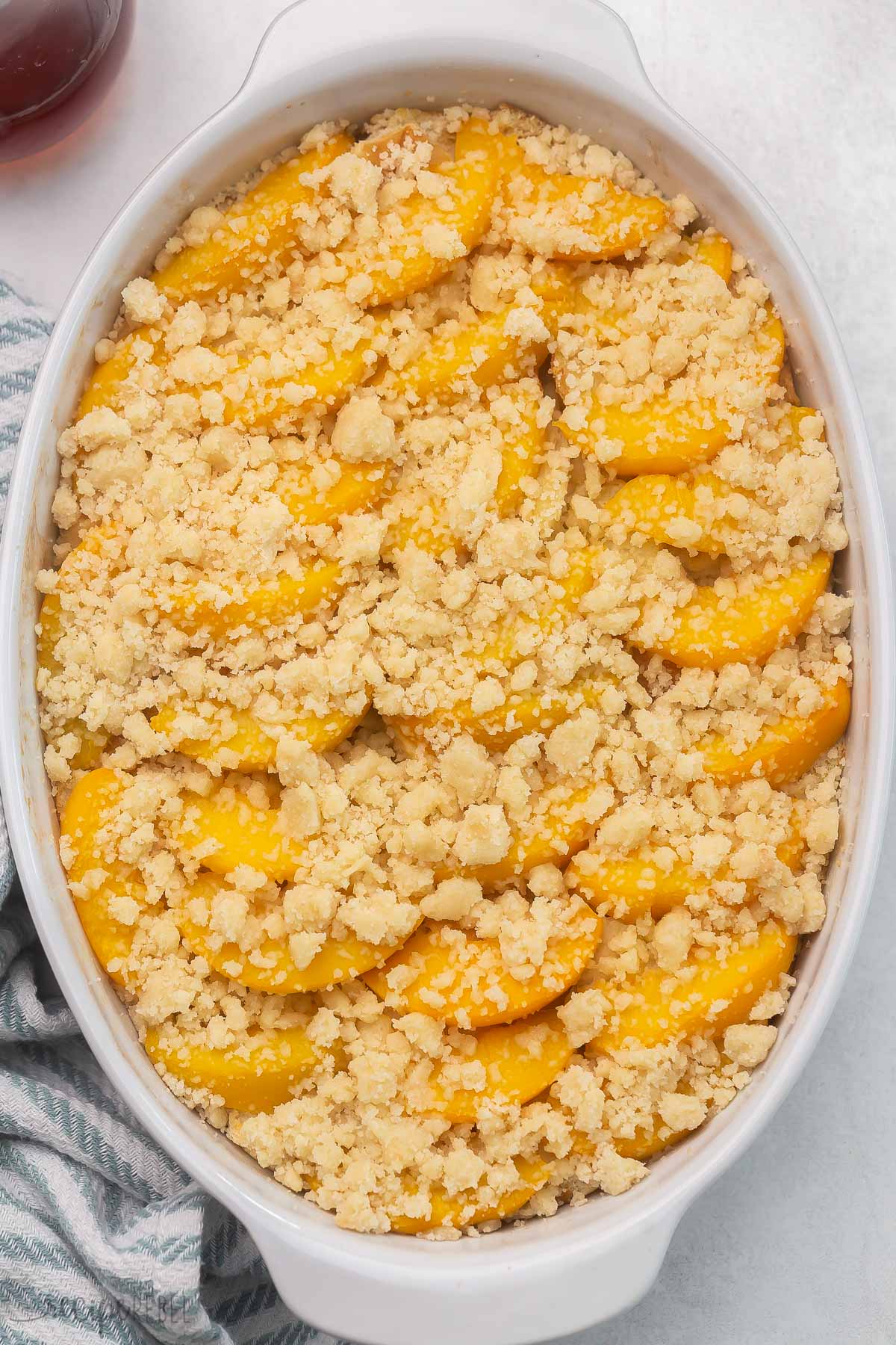 Top view of Peach Cobbler French Toast in a casserole dish. 