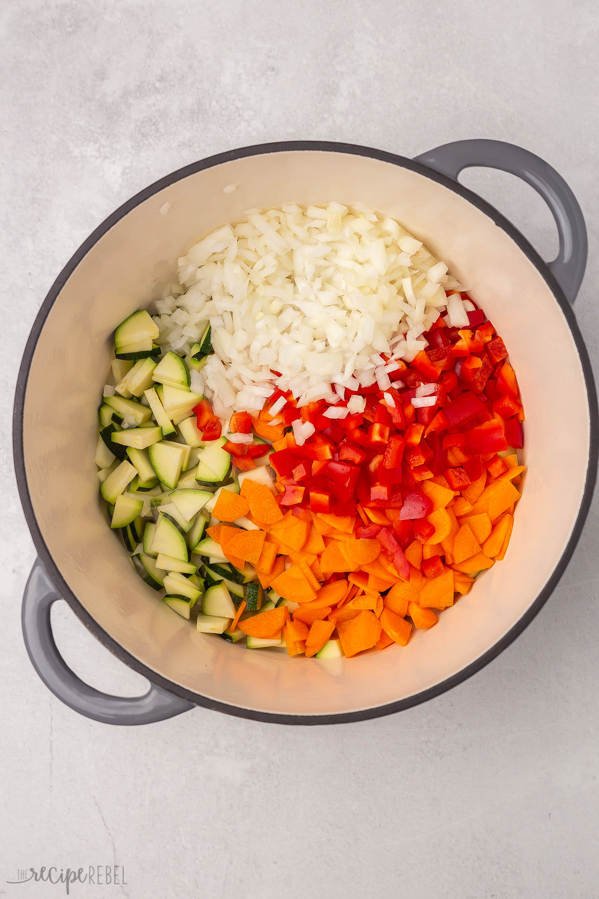 Top view of cooking pot with chopped vegetables in it.