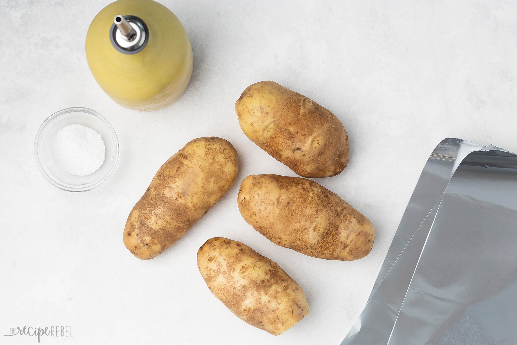 Top view of simple ingredients needed to make baked potatoes on the grill. 