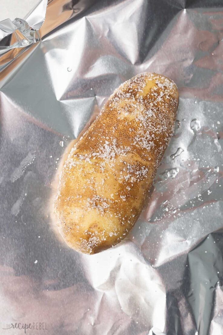 Top view of seasoned potato sitting on foil. 