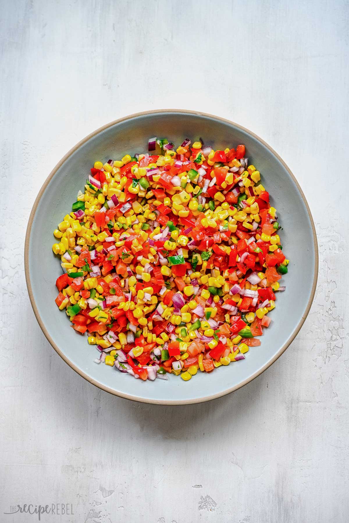 Top view of a big bowl of fresh corn salsa.