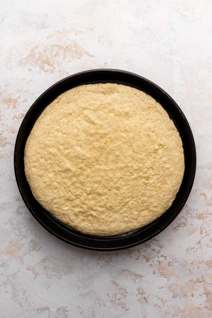 Top view of sugar cookie base in a pizza pan. 