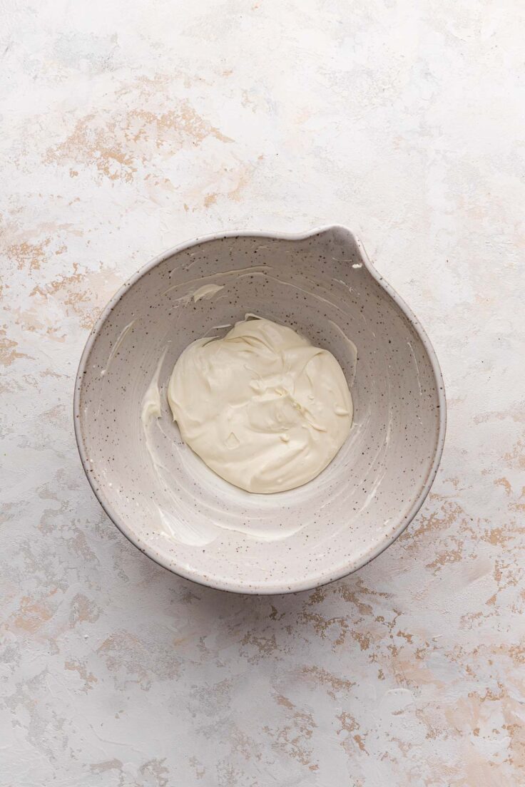 Top view of mixing bowl with cream cheese mix in it. 