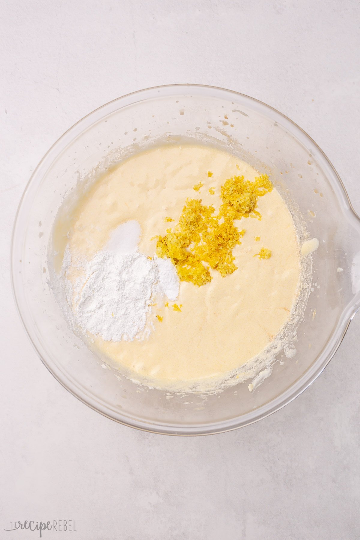 leaveners and lemon zest added to bowl with cake batter.