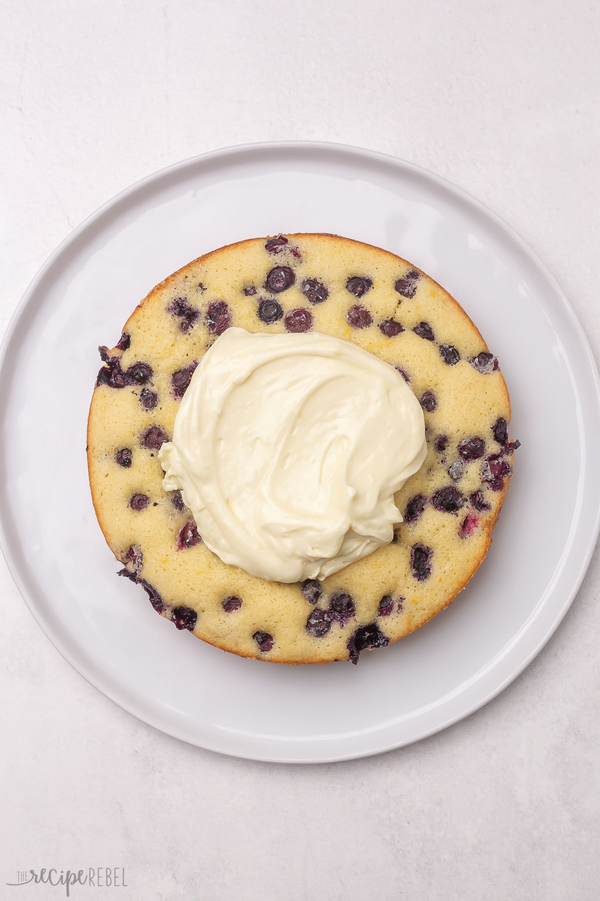 single layer of lemon blueberry cake with frosting on top.