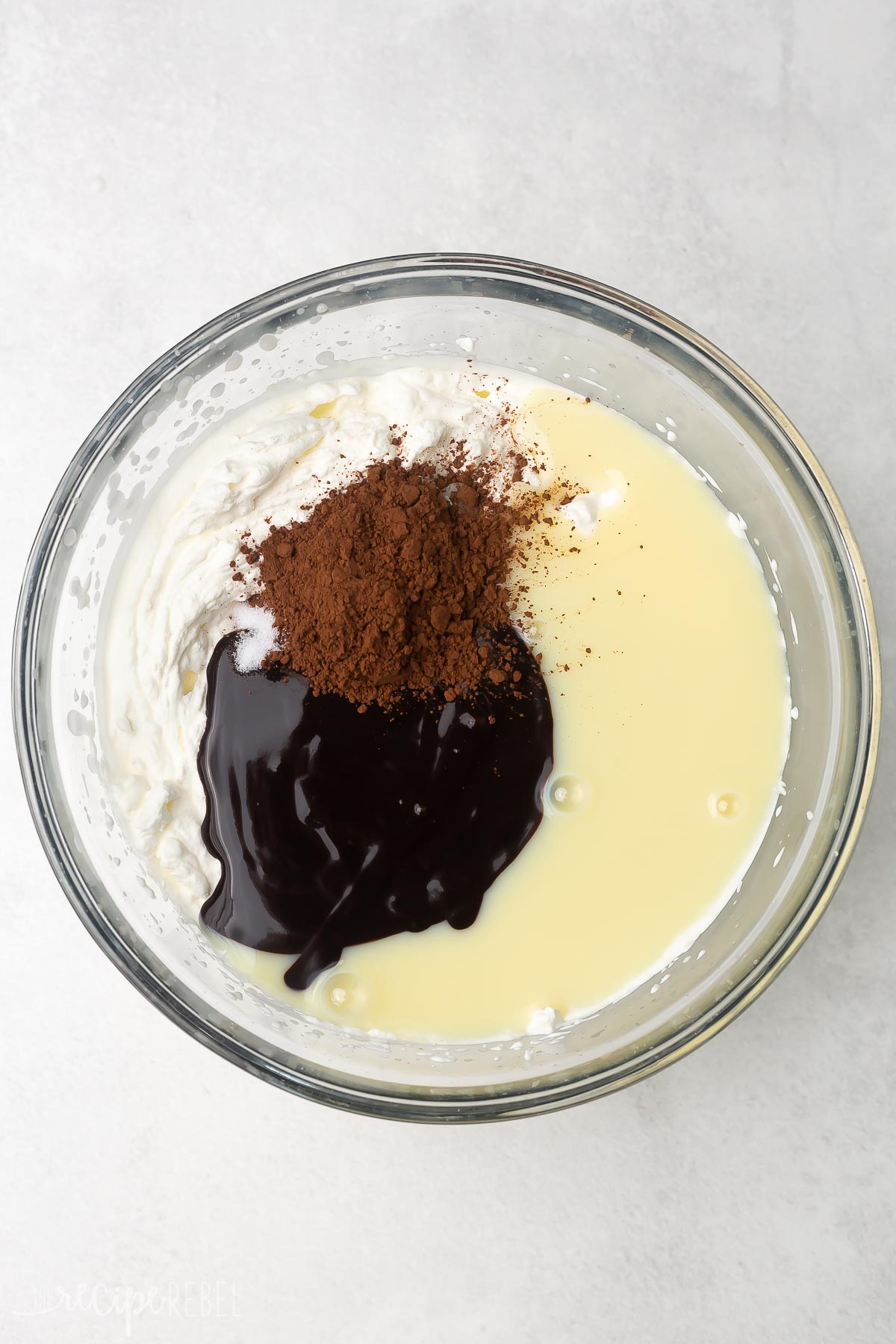 Top view ofglass mixing bowl with unmixed ingredients in it. 