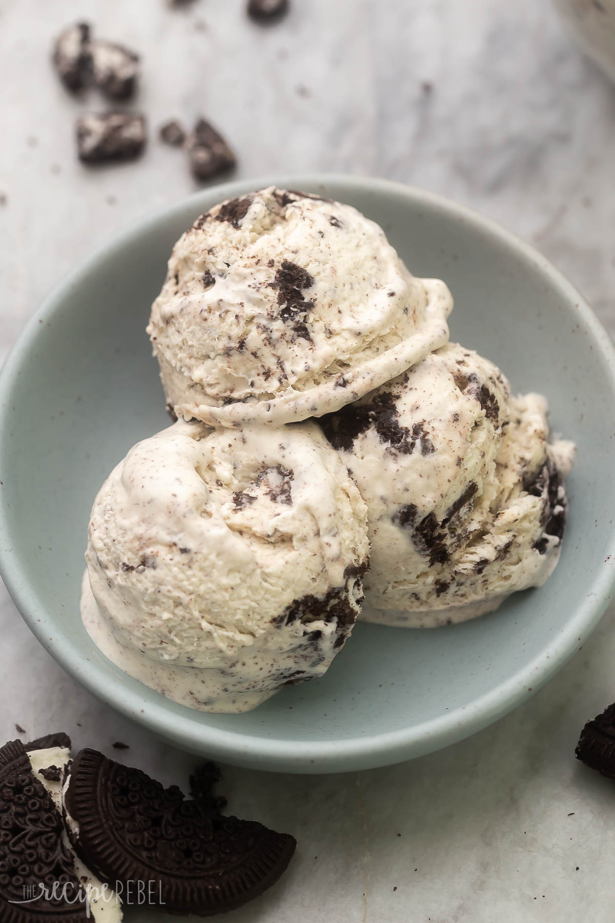 Close up of three scoops of Oreo Ice Cream in a blue bowl.