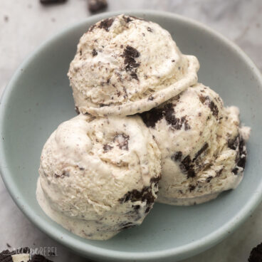 Close up of three scoops of Oreo Ice Cream in a blue bowl.