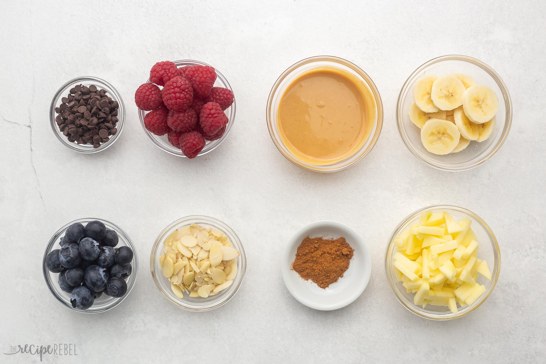 toppings in glass bowls for baked oatmeal cups.
