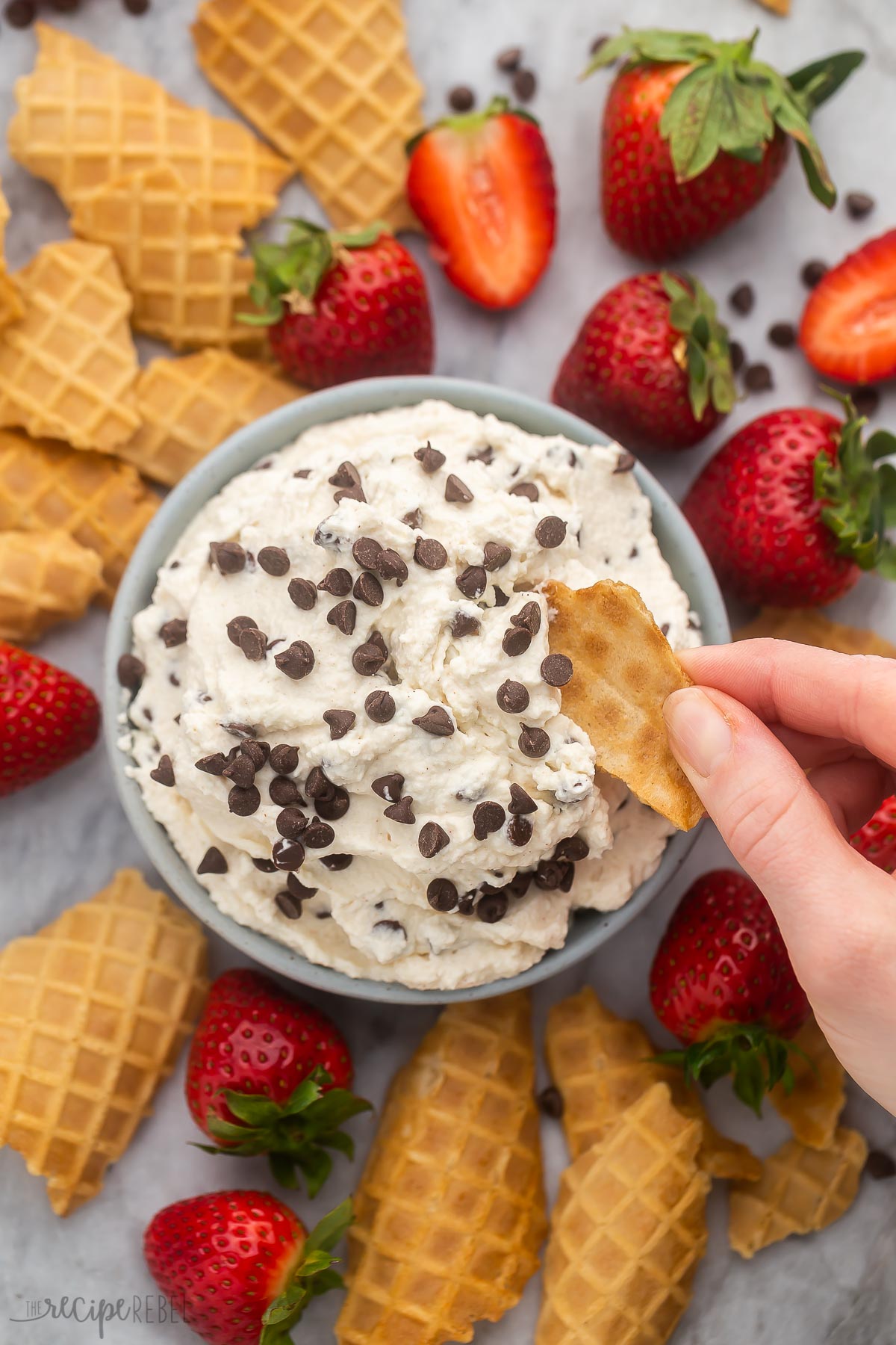 overhead shot of a cannoli dip being scooped from bowl.