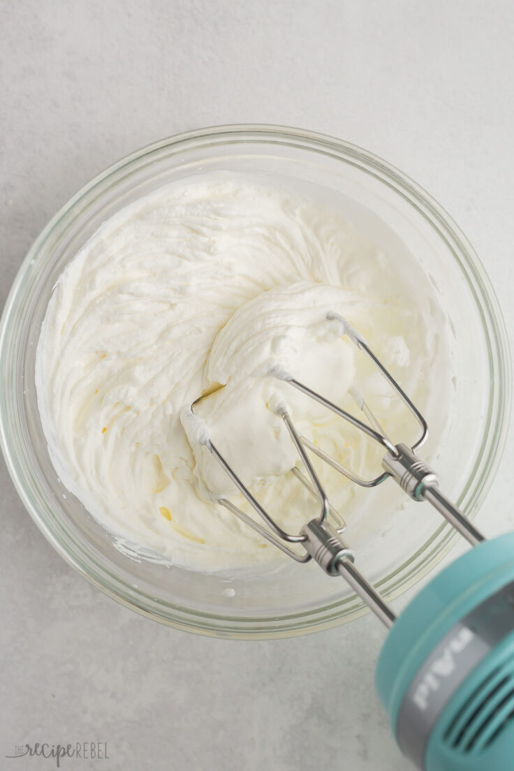 mixers in a glass bowl of whipped cream.