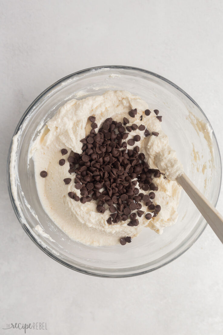 connoli dip mixed in glass bowl with chocolate chips added on top.