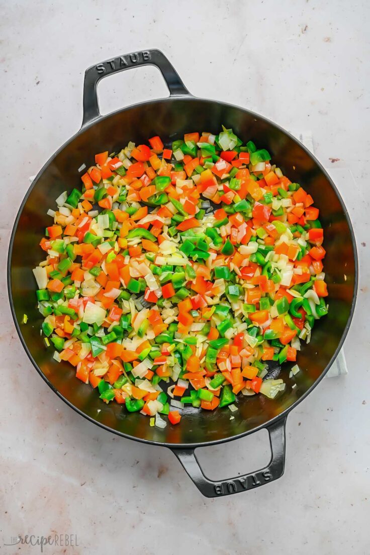 overhead shot of chopped vegetables in black pan.